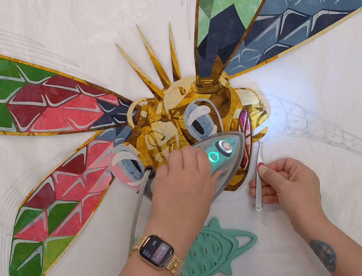 Kestrel using her M3Pro Oliso iron to put together a fused applique dragonfly